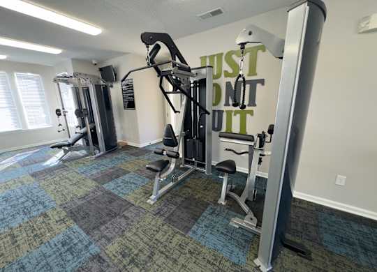 A gym with a sign that says "Just Don't Quit".