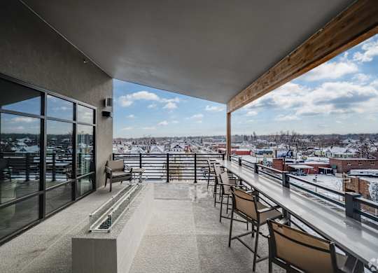Luxury Apartments for Rent in Greeley CO - The Shelby - Rooftop Balcony with Fire Pit, Seating, Wooden Design Details, and City Views