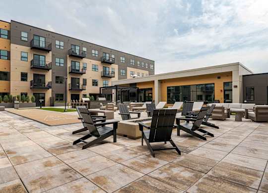 A modern building with a patio area in front.