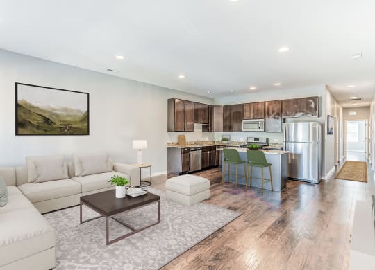 a living room and kitchen with a couch and a table