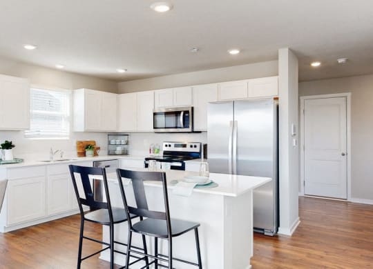 a kitchen with a island and a refrigerator