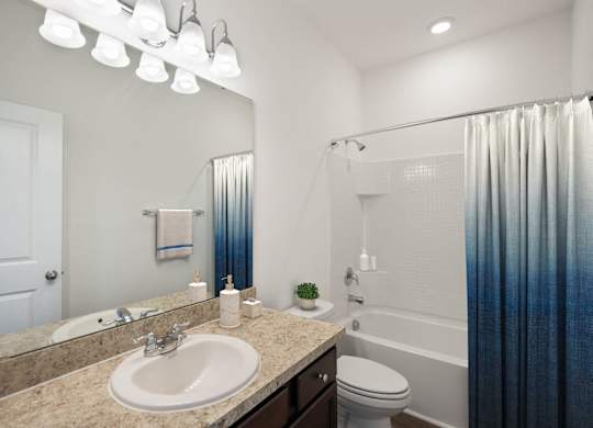 A bathroom with a sink, toilet, and shower.