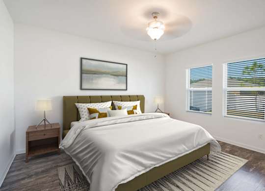 A bedroom with a large bed and a painting on the wall.