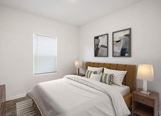 A bedroom with a bed, nightstands, and two framed pictures on the wall.