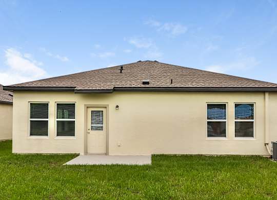 A house with a brown roof and a white door.