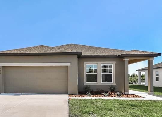 A house with a garage door and a window.