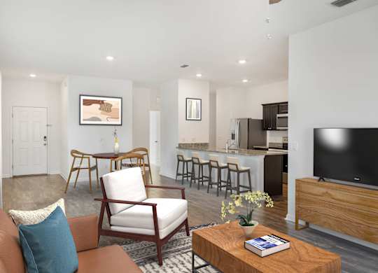 A living room with a brown couch, a wooden coffee table, and a television.