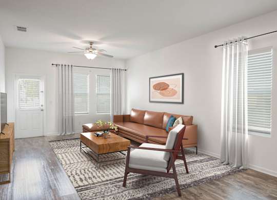 A living room with a brown couch, a coffee table, and a ceiling fan.