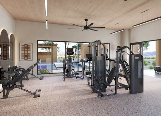 A spacious gym with a variety of equipment and a view of the outdoors.