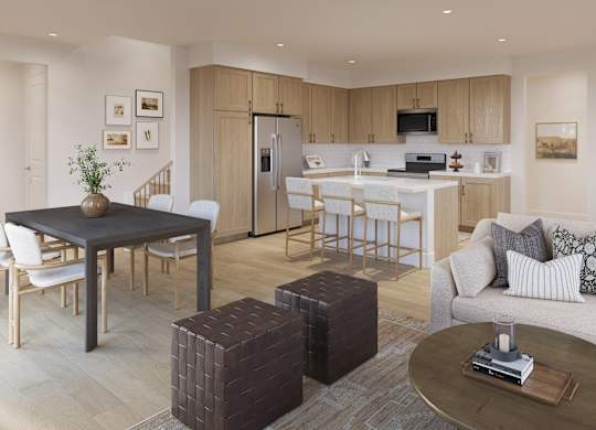 A modern living room with a dining area and kitchen in the background.