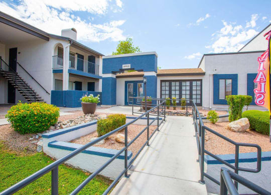 a building with stairs and a walkway leading to it