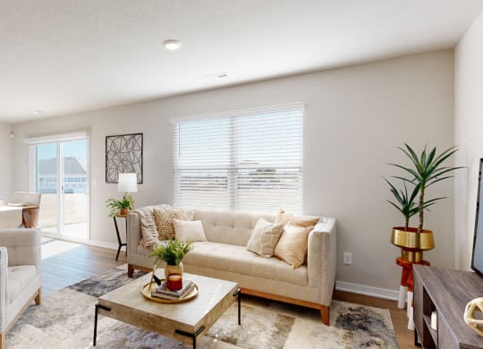 a living room with couches and chairs and a table