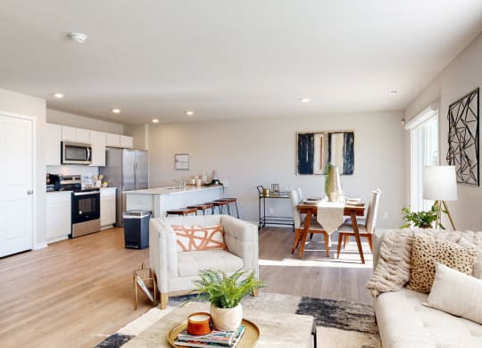 a living room and kitchen with a couch and a table