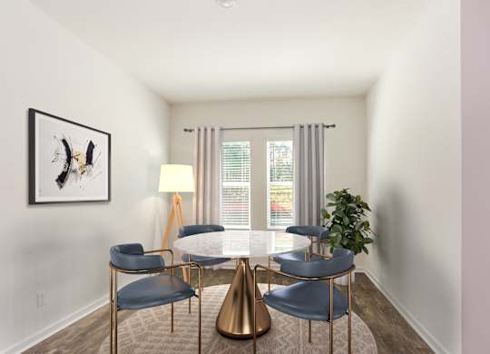 A modern dining room with a gold table and chairs.