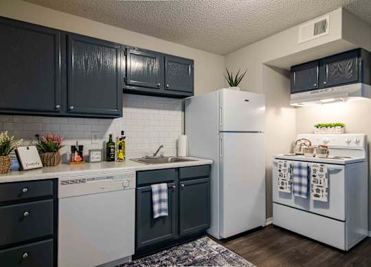 Kitchen with white appliances and ample cabinet space at Mableton Ridge Apartments in Mableton, GA, near Douglasville.