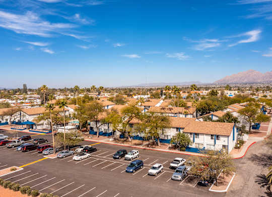 Property view with parking area at Midtown on Seneca, a pet-friendly apartment community near East Central Tucson, Tucson, AZ.