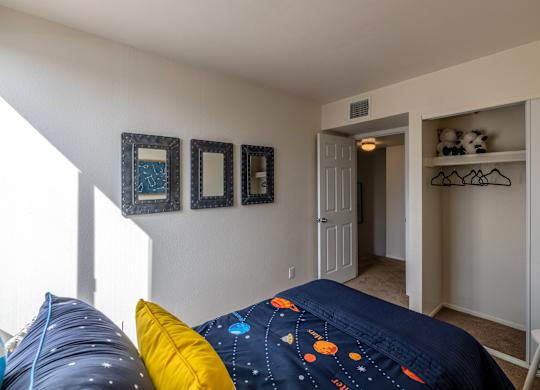 Bedroom with large closet and window at Midtown on Seneca, a pet-friendly apartment community near East Central Tucson, Tucson, AZ.