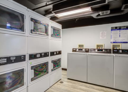 a row of microwaves in a room with other machines