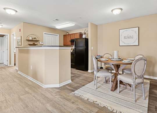Apartments in Sevierville for Rent – Overlook at Allensville - A kitchen with a table and chairs in the middle of the room.
