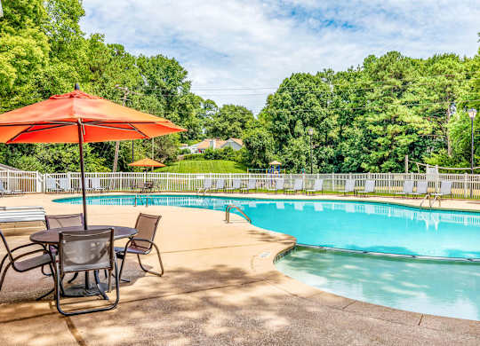 Swimming pool with lounge seating at Grand Arbor Reserve Apartments in Raleigh, NC 27607, near Central Raleigh.
