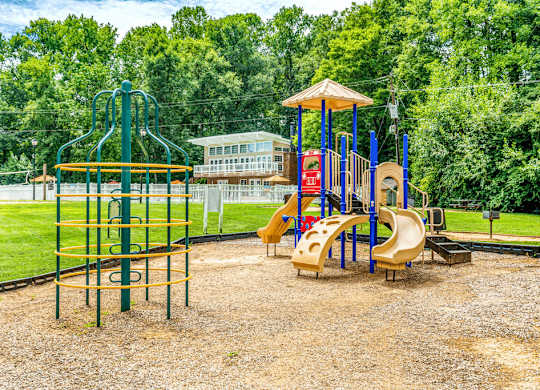 Community playground with safe play structures at Grand Arbor Reserve Apartments in Raleigh, NC 27607, near Central Raleigh