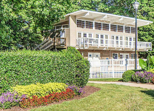 Exterior of apartment building surrounded by lush greenery at Grand Arbor Reserve Apartments in Raleigh, NC 27607, near Central Raleigh.