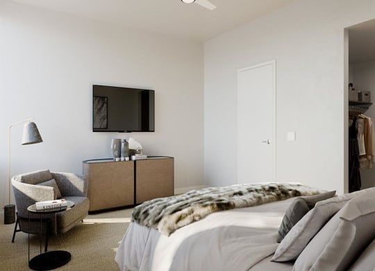 a bedroom with a bed and a television on the wall