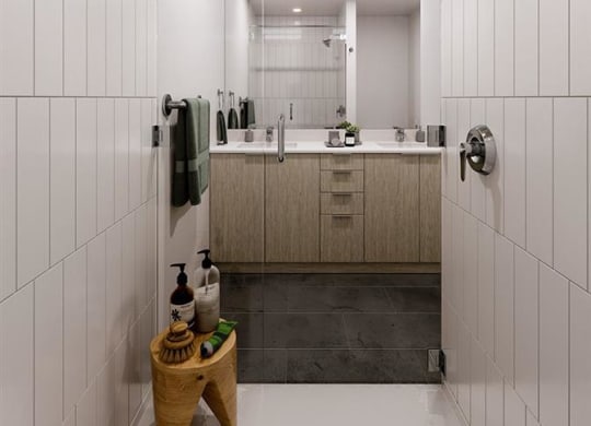 a bathroom with a large mirror and a shower