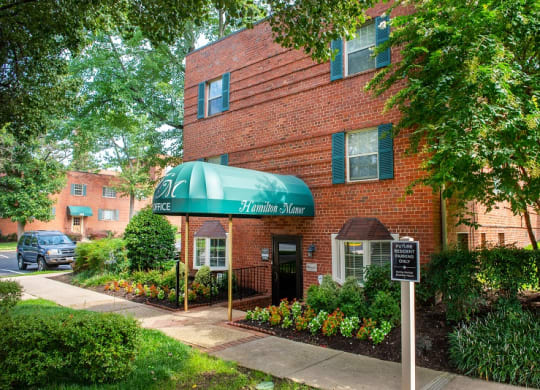 our apartments are located in a brick building with a green awning