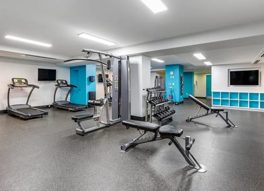 the gym in the basement of a building with exercise equipment