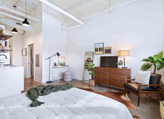 a bedroom with a bed and a rug on the floor
