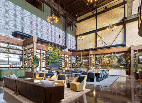 a rendering of the lobby of a building with furniture and tables