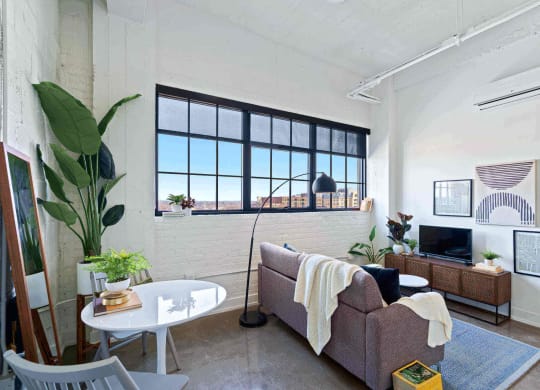 a living room with a couch and a table and a window