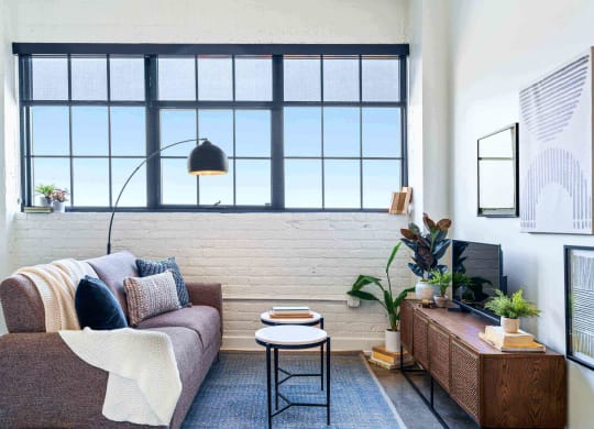 a living room with a couch and a window