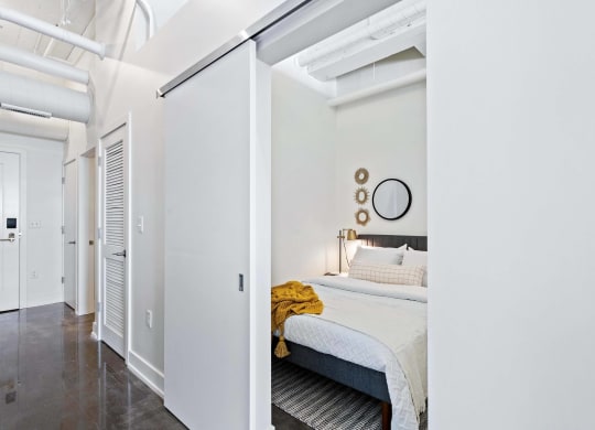 a bedroom with a bed and a sliding glass door