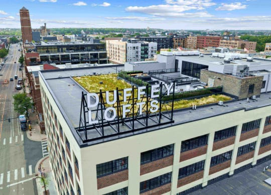 an aerial view of a building with a green roof