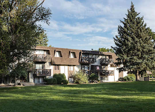 Wide view of apartment buildings and maintained green spaces at Willowstone Apartments in Denver CO 80231