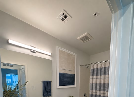 A bathroom with a toilet, sink, and shower.