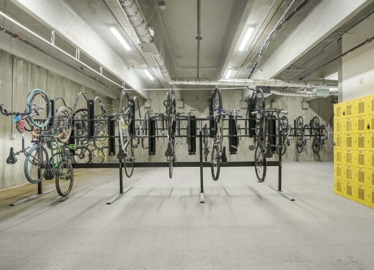 a room full of bikes on racks in a parking garage