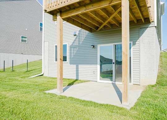 A house with a grey siding and a wooden pergola.