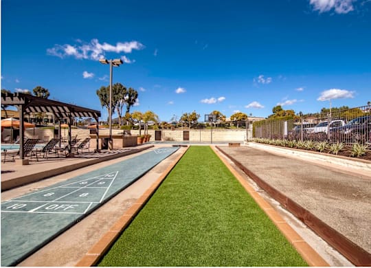 a basketball court in a park next to a road