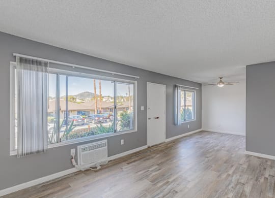 Dog Friendly Apartments in El Cajon CA - Ivanhoe Village - Unfurnished Open-Concept Living Room with Large Window and Sliding Glass Door to Patio