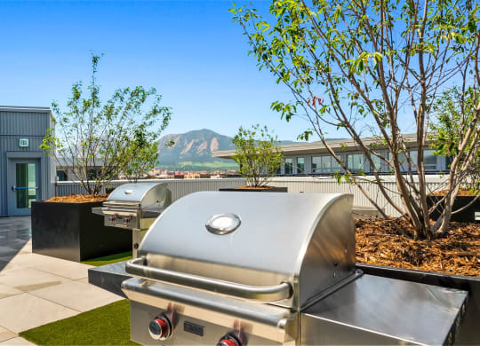 a bbq grill on the rooftop patio of Platform with mountain views