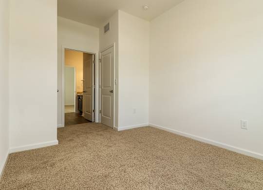 A room with carpeted floor and white walls.