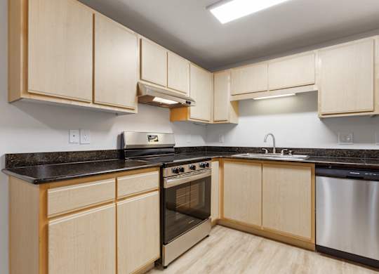 A kitchen with wooden cabinets and stainless steel appliances.
