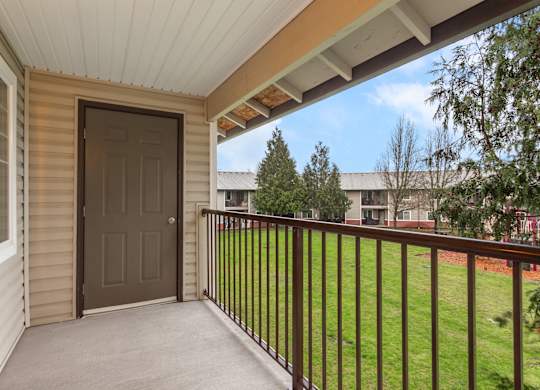 A brown door is on the side of a house.