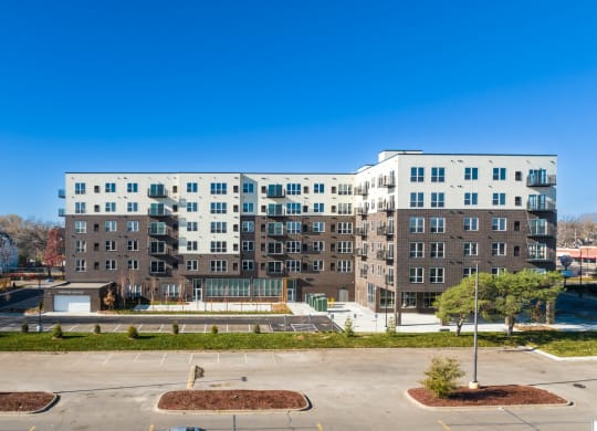a large apartment building with a fountain in front of it