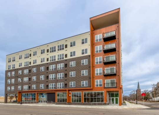 a large apartment building on the corner of a street