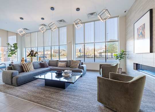 A modern living room with a large sectional sofa and a glass coffee table.