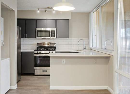 Kitchen with sleek stainless-steel appliances at Sentry Tempe apartments in Tempe near Mesa, Arizona